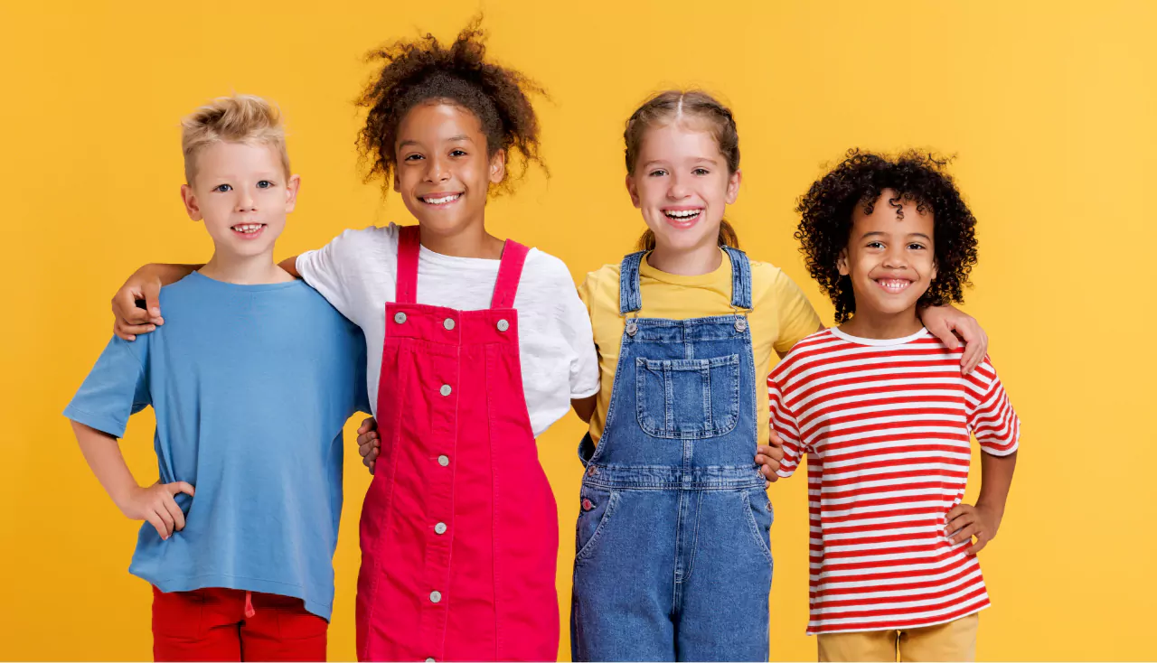 Group of cheerful happy multinational children on yellow background
