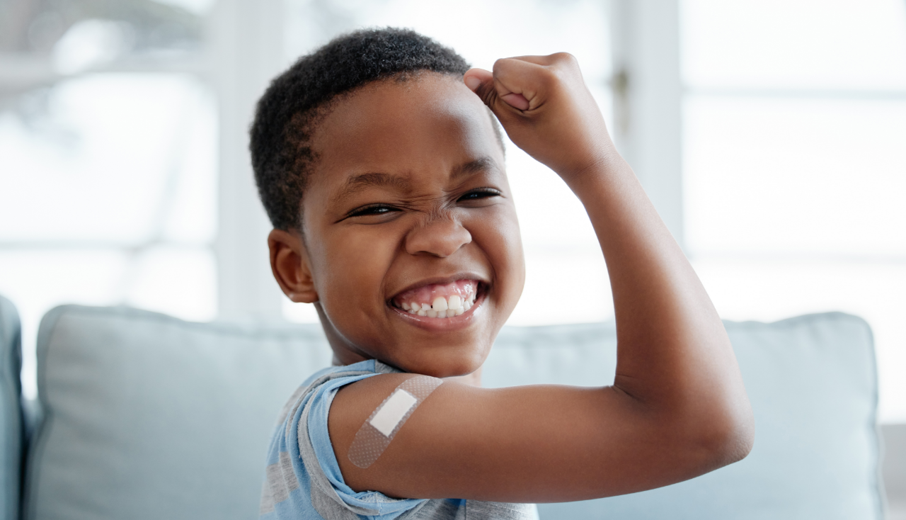 African boy kid, vaccine and portrait with smile, medicine and flex muscle for wellness in hospital. Male child, strong and excited with plaster for injection, healthcare and injection to stop virus