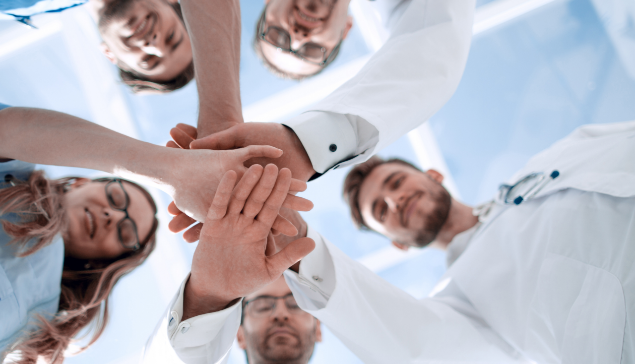 Portrait of a doctor team connecting hands stacking