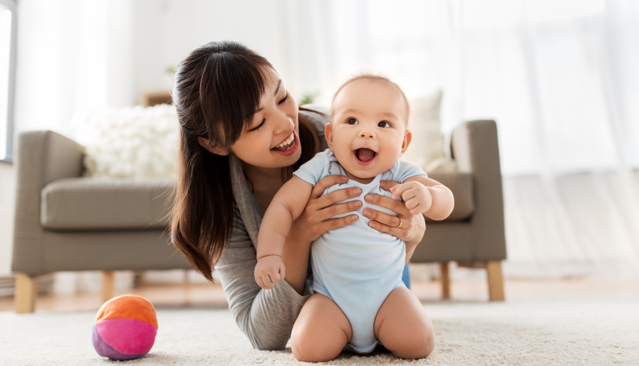 family and motherhood concept - happy smiling young asian mother with little baby at home