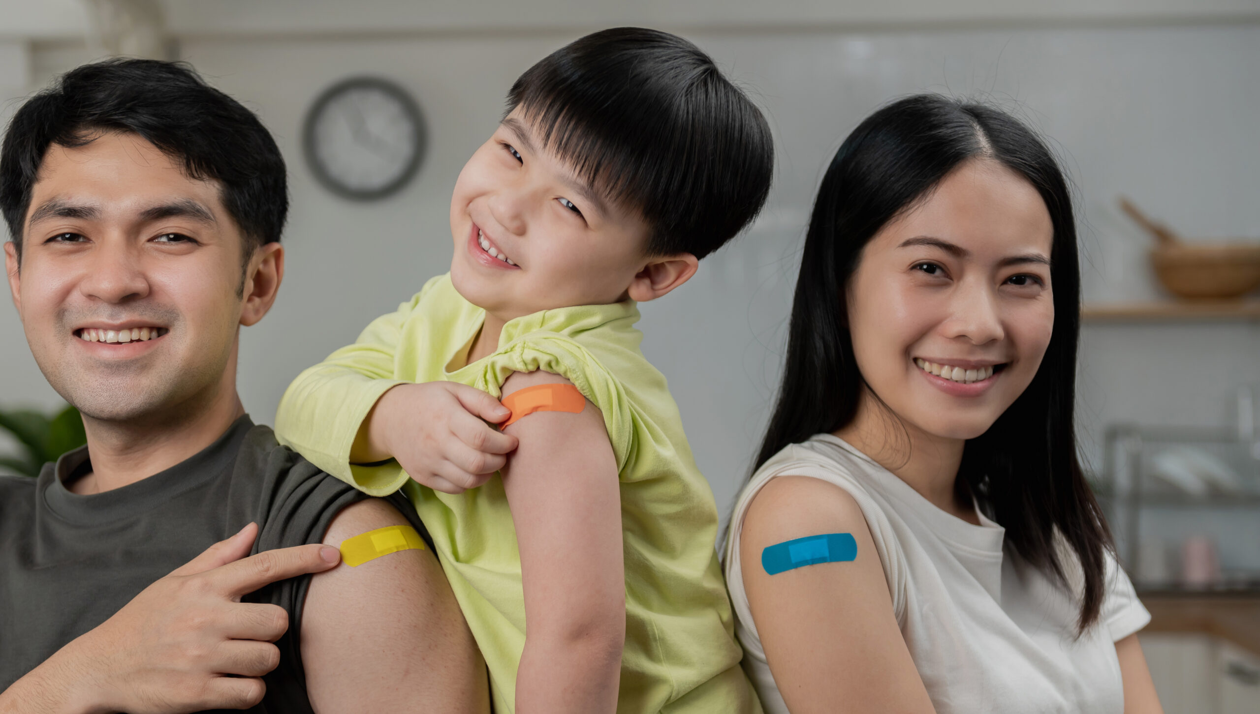 Happy Vaccinated asian family Showing Arm With Bandage After Vaccine Injection , Smiling To Camera. New normal back to school concept