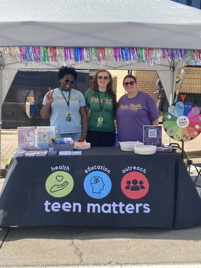 Group of Northeast Health District Health Educators at a community festival in downtown Athens, providing table of educational information.