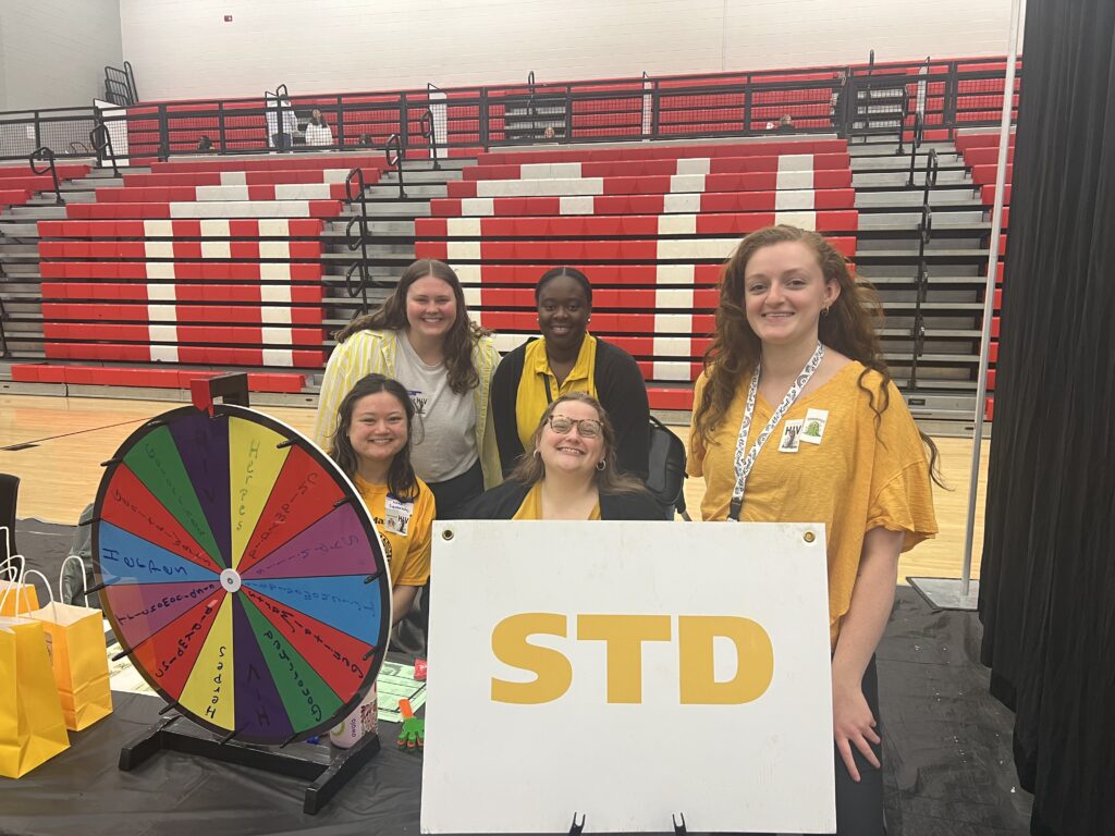 Group of Northeast Health District Health Educators at a Teen Maze event, providing table of educational information and activities.